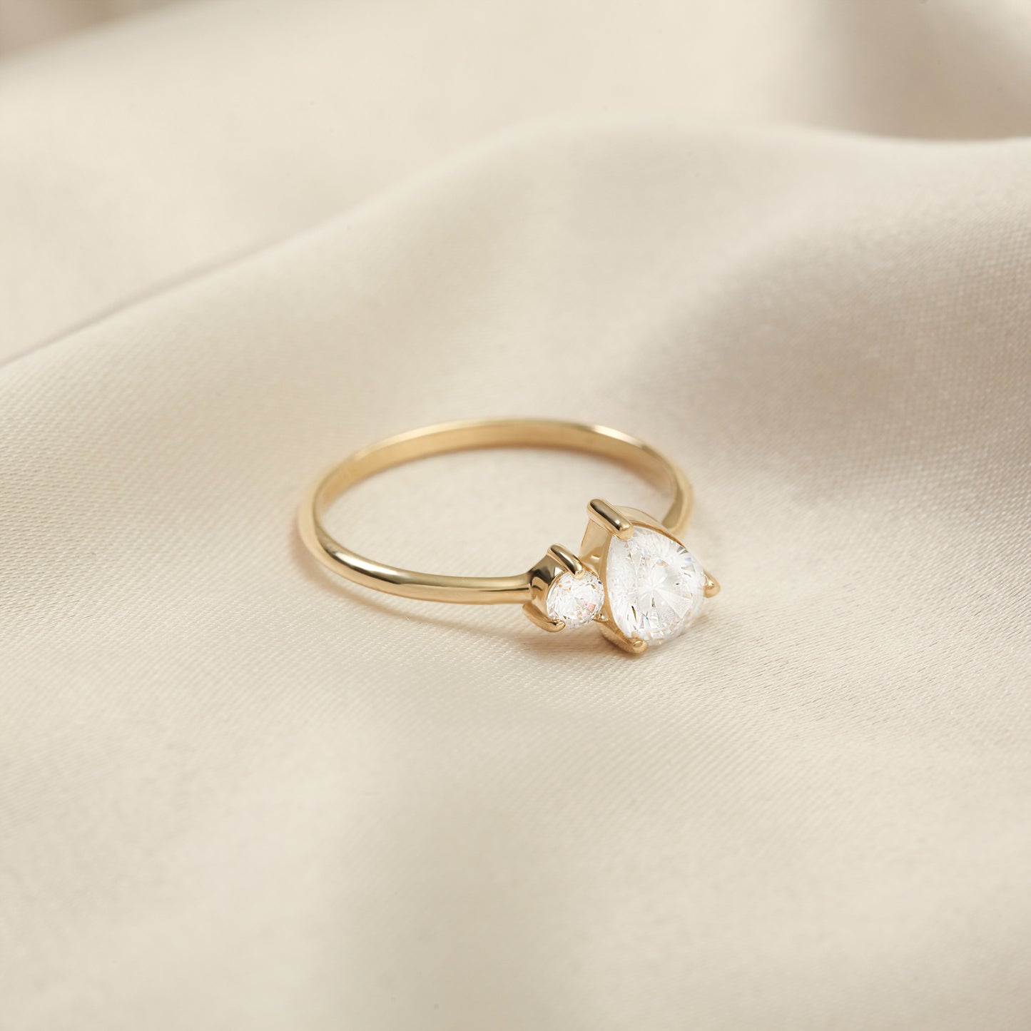 You & Me CZ Ring in 14K Gold – Pear & Round Stones