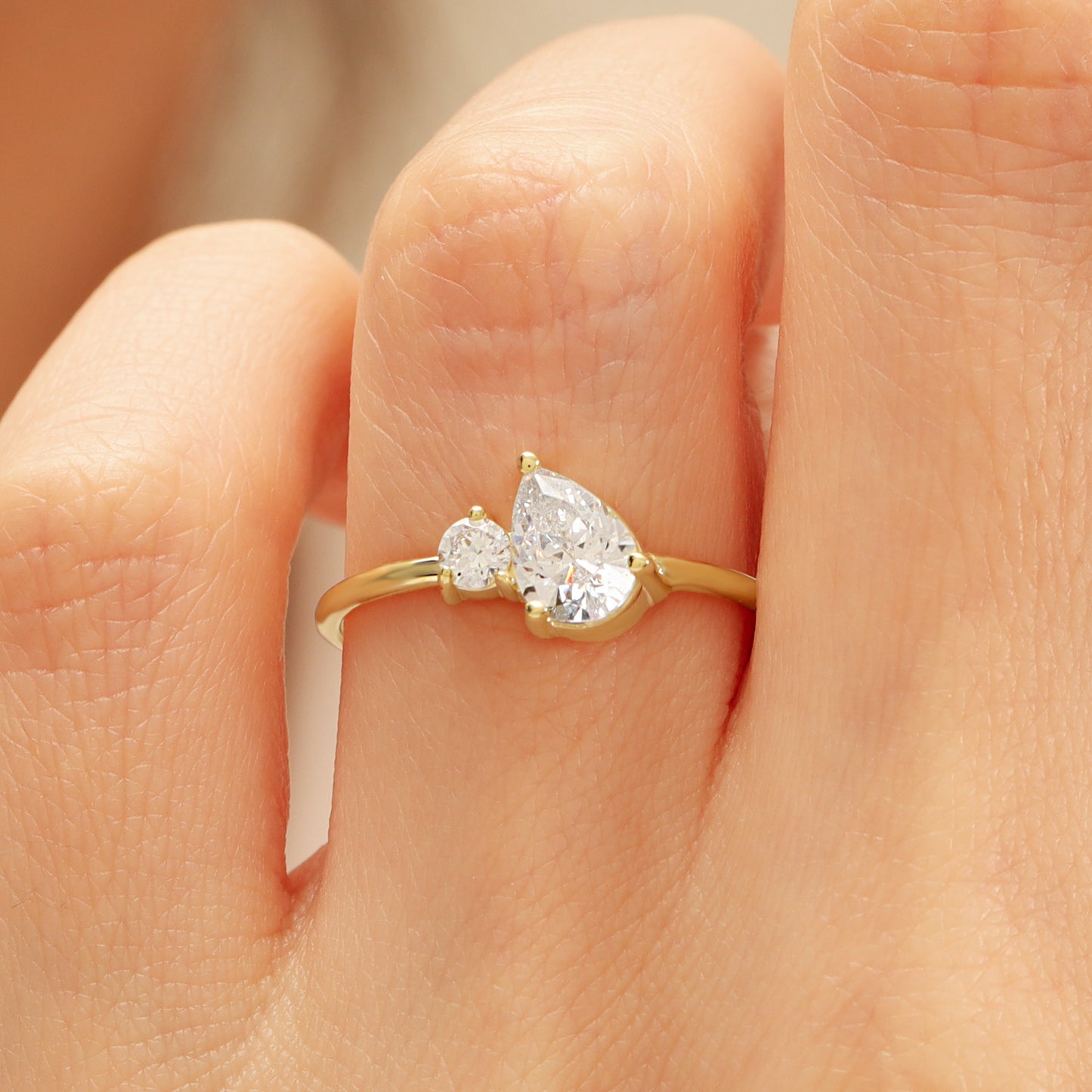 You & Me CZ Ring in 14K Gold – Pear & Round Stones